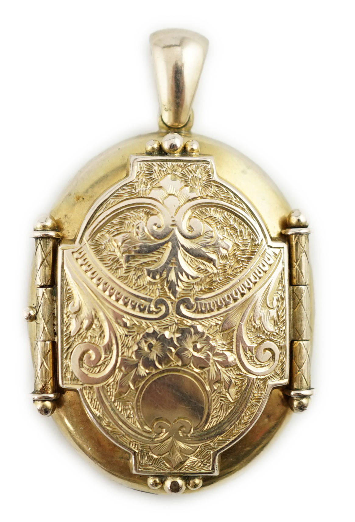 A Victorian floral and scroll engraved locket